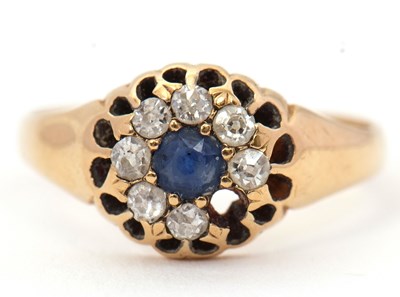 Lot 69 - A sapphire and diamond ring, the central round...