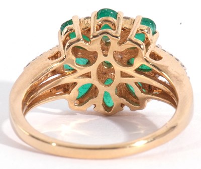 Lot 115 - Modern 18ct gold emerald and diamond cluster...