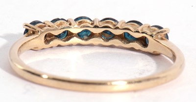 Lot 129 - Modern 9ct gold blue topaz ring, line set with...