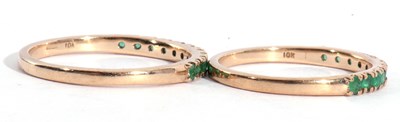 Lot 130 - Two modern 9ct gold and emerald half hoop...