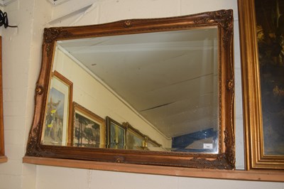 Lot 199 - A modern rectangular bevelled wall mirror in a...