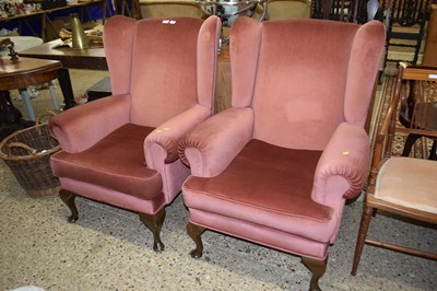 Lot 234 - A pair of wing back armchairs