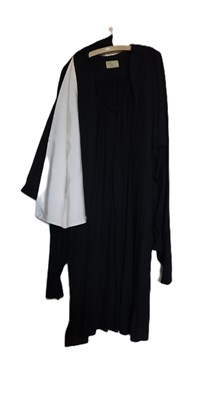 Lot 228 - An academic gown, the open fronted black robe...