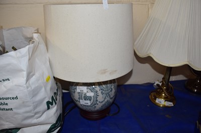 Lot 528 - A blue and white ceramic lamp and shade