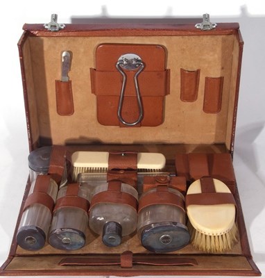 Lot 215 - George V brown leather vanity case containing...