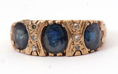 Lot 18 - A sapphire and diamond ring, the three...