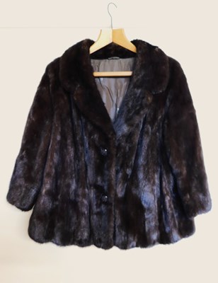 Lot 101 - A lady's brown fur jacket, with hook fastening...