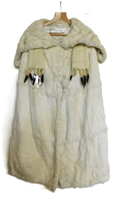 Lot 94 - A full length white fur cape, with deep turn...