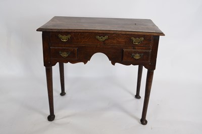 Lot 285 - George III oak lowboy, fitted with one long...
