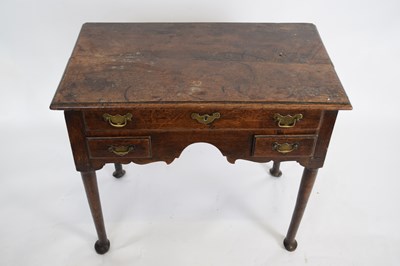 Lot 285 - George III oak lowboy, fitted with one long...