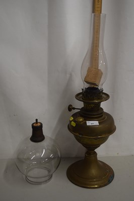 Lot 27 - A brass oil lamp and shade