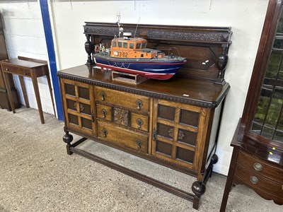 Lot 306 - An oak sideboard with teardrop handles on...