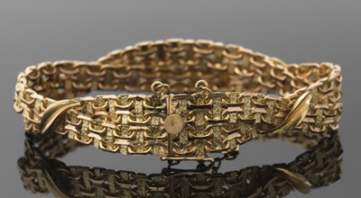 Lot 420 - A gold bracelet, the two rows of textred links...