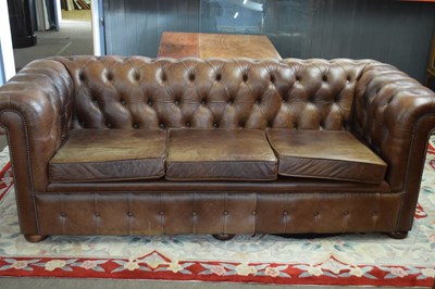 Lot 411 - Brown leather Chesterfield style three seater...