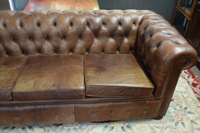 Lot 411 - Brown leather Chesterfield style three seater...