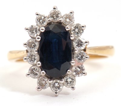 Lot 10 - An 18ct sapphire and diamond ring, the oval...