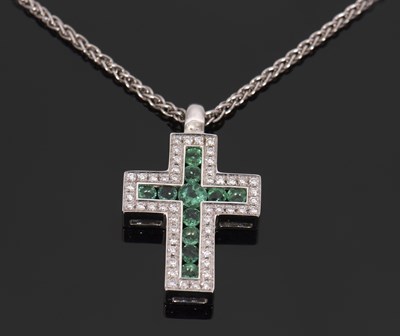 Lot 436 - An 18ct white gold emerald and diamond cross...