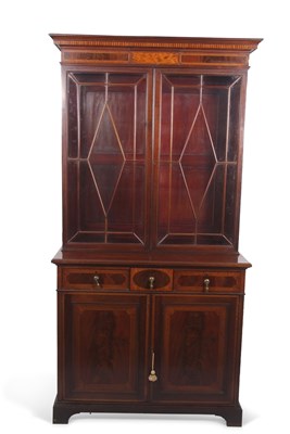 Lot 553 - An Edwardian mahogany bookcase cabinet formed...