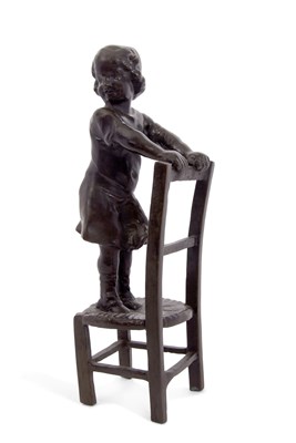 Lot 496 - An early 20th Century bronze model of a girl...