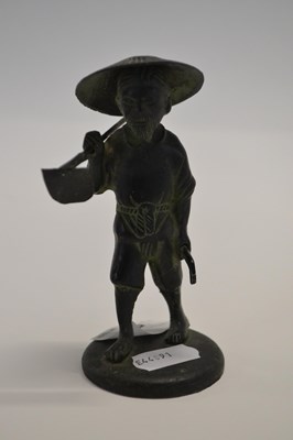 Lot 356 - A small bronzed figure of a Chinese workman on...