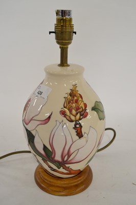 Lot 426 - A Moorcroft table lamp, the white ground with...