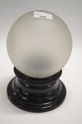 Lot 546 - A frosted glass globe on wooden stand