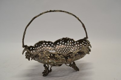 Lot 553 - A white metal small basket of lobed form with...