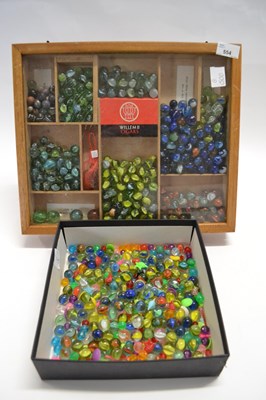 Lot 554 - A quantity of marbles, one in wooden case