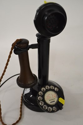 Lot 595 - A vintage bakelite stick telephone, 30cm high