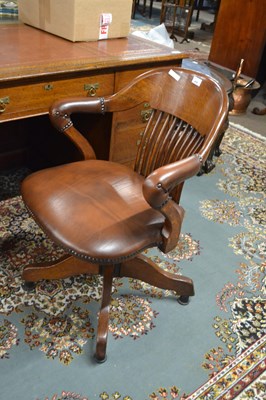 Lot 616 - An early 20th Century oak bow back revolving...