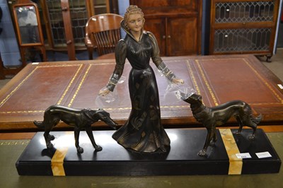 Lot 622 - An Art Deco bronzed metal group of a lady with...