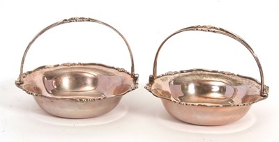 Lot 10 - A pair of George V silver swing handled bon...