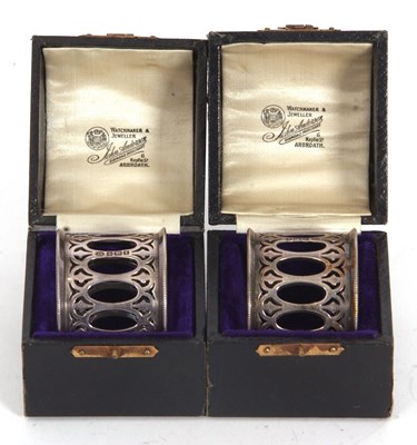 Lot 23 - A pair of George V silver serviette rings,...