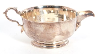 Lot 28 - A George V silver cream jug of plain circular...