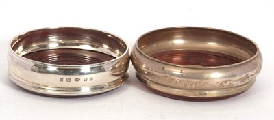 Lot 71 - Two silver bottle coasters of plain form with...