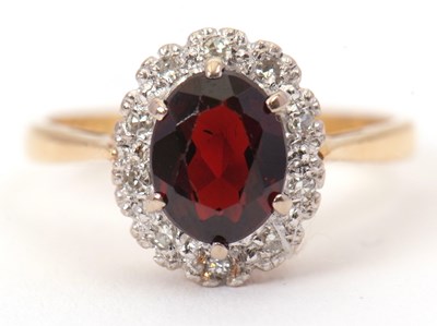 Lot 6 - A garnet and diamond cluster ring, the central...