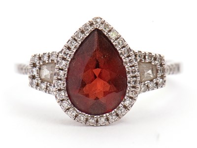 Lot 7 - An 18ct garnet and diamond ring, the pear...