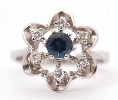 Lot 10 - An 18ct sapphire and diamond ring, the central...