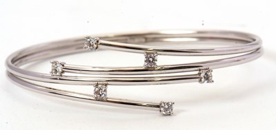 Lot 228 - A 9ct and CZ bangle, the four strand bangle...