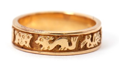 Lot 34 - A ring stamped 18K, the 5mm wide band with...