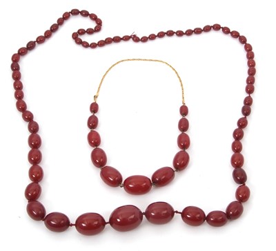 Lot 178 - Two 'cherry amber' bead necklaces, one with...