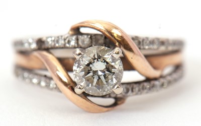 Lot 52 - A 14K diamond ring, the central round...