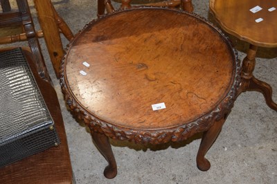 Lot 322 - A 20th Century walnut coffee table with carved...