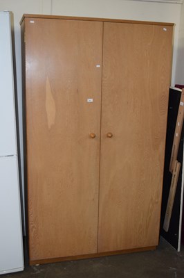 Lot 671 - A light wood finish two door wardrobe