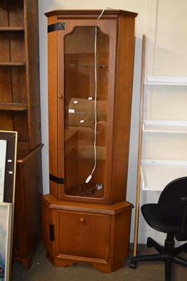 Lot 691 - A teak finish corner display cabinet