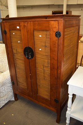 Lot 737 - A modern Oriental two door television cabinet