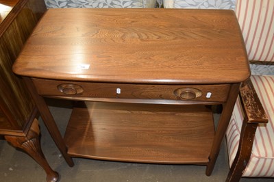 Lot 770 - An Ercol single drawer side table with base shelf