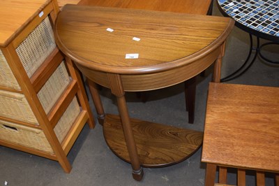 Lot 790 - An Ercol light elm half moon hall table