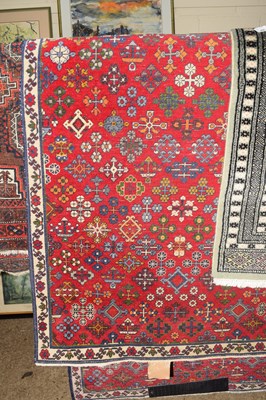 Lot 403 - WOOL FLOOR RUG DECORATED WITH MOTIFS ON A RED...