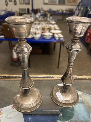 Lot 110A - A pair of filled silver mounted candlesticks...